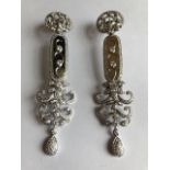 A pair of Art Deco style diamond set pendant earrings, the pierced circular drops suspending