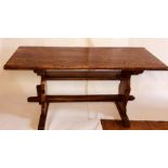An early 19th Century elm and ash trestle table, circa 1815, rectangular top, peg joined dual