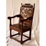 A William & Mary oak wainscot armchair, circa 1690, acorn finials on a scrolled top with floral