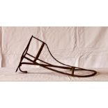 A late 19th century cast iron horse saddle rack with a bridle hanger.