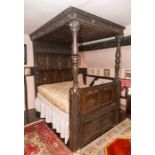 A James I oak tester bed, circa 1614 (carved on pediment), foliate carved pediment with carved