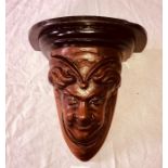 A Henri II revival French walnut wall bracket, carving of a face and foliage. 25cm H