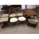 An Ercol Windsor drop-leaf D-end dining table and four spindle back chairs, together with an