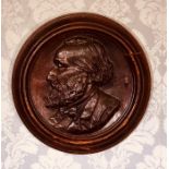 An early 19th century oak wall plaque, moulded frame with a carved portrait. 36cm x 36cm