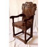 A Charles II oak carved wainscot chair, circa 1650, scrolled carving top rail, above a moulded panel