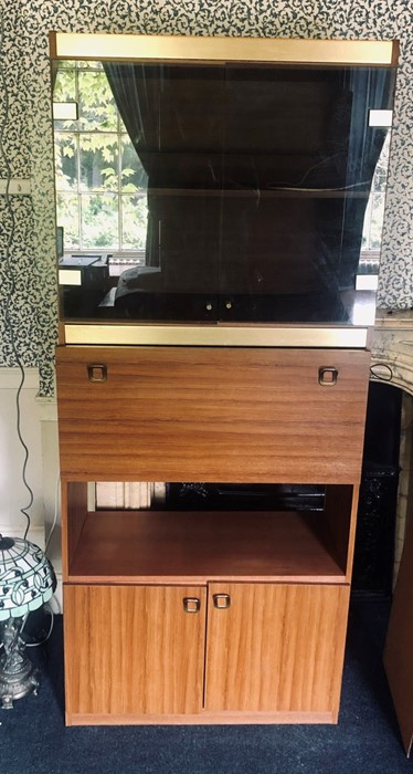 A 1970's teak display shelf unit, glazed display cupboard opening to two tier shelves, above a
