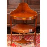 An early 19th Century inlaid mahogany corner washstand, two third carved gallery on two tier