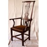 An 18th Century elm tall back carver armchair, scrolled shape top with a pierced vase shape splat