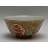 A Chinese porcelain footed bowl, the frieze painted with alternating roundels of dragons chasing