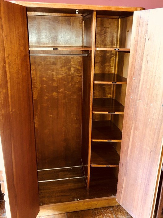 A 1960's walnut gentleman's wardrobe, two panel doors with brass handles opening to a chrome clothes - Image 2 of 2