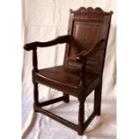 A Charles I oak wainscot chair, circa 1630, scrolled foliate carved back rail on a moulded panel