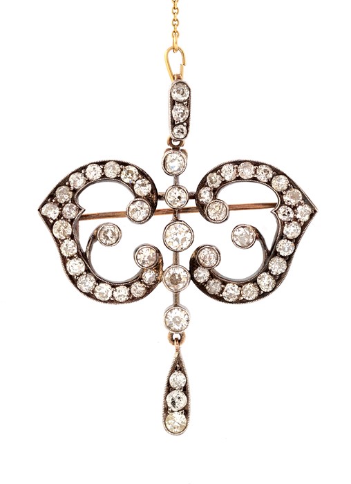 A late Victorian/early Edwardian diamond set brooch pendant, comprising five graduated old cut