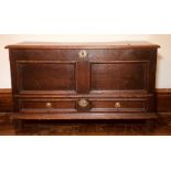 A Queen Anne oak mule chest, circa 1705, rectangular lid above two moulded panels, brass foliate