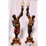 A pair of late 19th Century Venetian Blackamore torchere stands, carved ebonised wood with gesso and