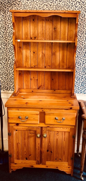 A 20th Century pine dresser, fitted with three tier plate rack on a rectangular dresser with two