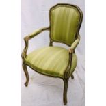 A Louis XIV style upholstered open armchair, shield back rest united with scrolled arms, raised on