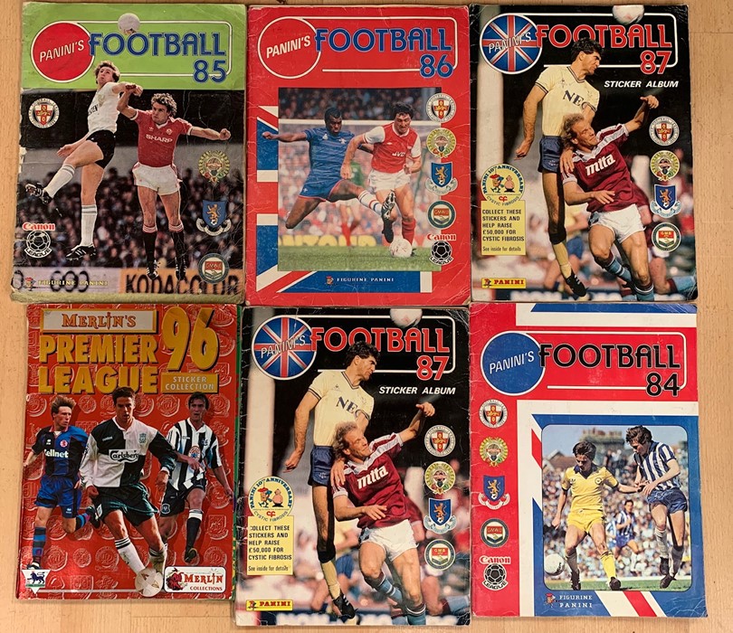 A small collection of football sticker albums comprising: Panini Football 84 (complete); Panini