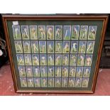 A framed full set of 50 Players Cigarette cards "Cricketers 1930".  A double sided frame, 46cm x
