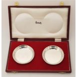 A pair of limited edition Harrods (retailed) cased silver circular dishes, by S J Rose & Son,