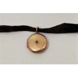 A yellow metal diamond set circular locket, one side set single rose cut diamond, diameter 24mm,