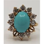 An 18ct. gold, turquoise and diamond dress ring, the oval mount set cabochon turquise to centre
