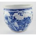 A large Chinese blue and white jardiniere, decorated with an exotic bird looking up and resting on a