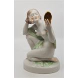 A Herend hand painted porcelain figurine, model no.5724, in the Art deco style, of a knelling lady