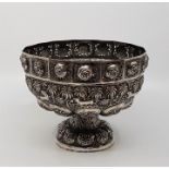 A 19th century Indian silver pedestal bowl, having repeating lions mask and pierced foliate panels