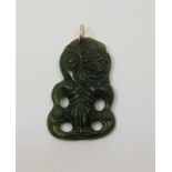 A Maori spinach jade anthropomorphic pendant, pierced and carved, height 37mm.  Condition: Good,