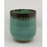 Abdo Nagi (Yemeni 1941-2001), a studio pottery vase, turquoise and brown glaze with bronzed rim,