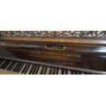An early 20th century walnut upright piano, (collection from Kingston area)