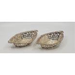 A pair of Edwardian navette form silver bon bon dishes, having gadrooned rims and pierced side, by