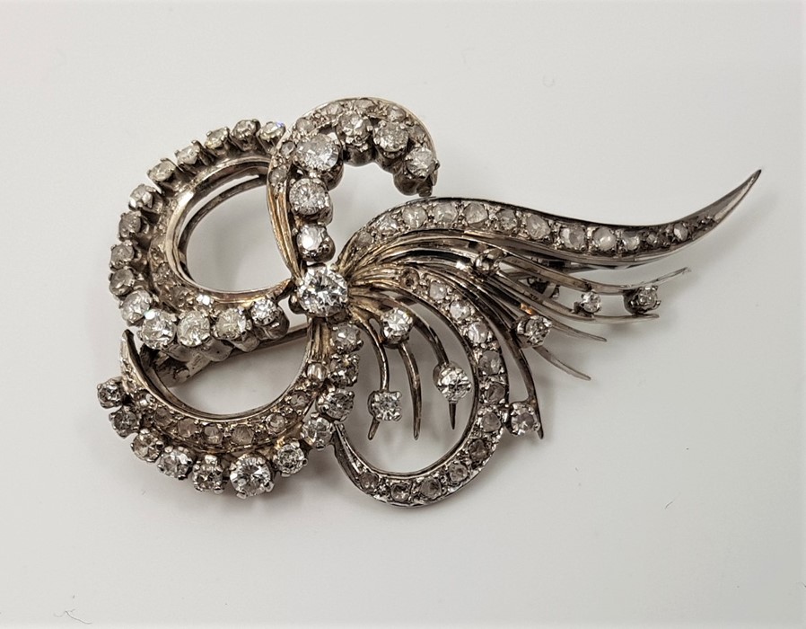 A precious white metal and diamond spray brooch, set numerous round brilliant, single and rose cut