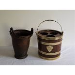 An 18th century copper bound leather fire bucket, height 29.5cm, the handle as found, together