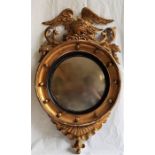 A Regency carved giltwood circular convex mirror, gilt circular frame with applied spheres and