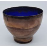 A studio pottery bowl, the exterior in copper coloured glaze, the interior blue, signed to base,