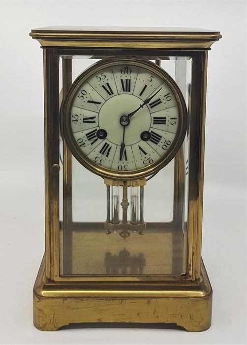 A 20th century French gilt brass mantle clock, gong strike, having circular white dial with Roman