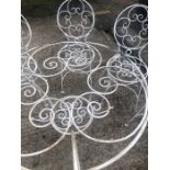 A 20th century white painted iron garden table and chairs.