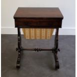 A Victorian rosewood combined work and games table, the swivel top folding out as a games table, the