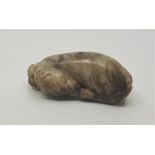 A carved jade figure of a sleeping dog, length 8cm.