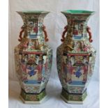 A large pair of 19th century Chinese famille rose vases, decorated in typical style both at fault,