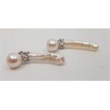 A pair of 18ct. gold, platinum, diamond, cultured and baroque pearl earrings, each having 18ct.