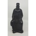 A Chinese Qing bronze seated figure, engraved dragon to belly, height 25cm.