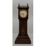 An early 20th century miniature walnut longcase clock, having white enamel Roman numeral dial, Buren