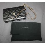 A Chanel wallet on chain with gold hardware in black lamb, with slip cover