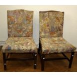 A pair of George III camel back library side chairs with stuff over gros point upholstery. Raised on