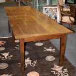 A 19th century elm oak and fruit wood folding dining table with clamped and planked top on a square