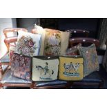 A collection of decorative scatter cushions including some petit point cushions with designs of Scot