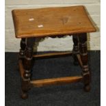 A 17th century style oak joint stool with turned and covered supports joined by stretchers. 44cm lon