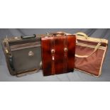 A 20th century tan leather music case with brass furniture together with other items of luggage (3)